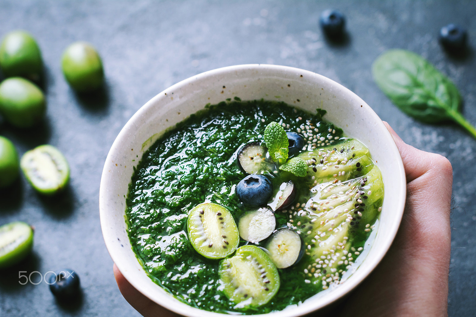 Nikon D7100 + Nikon AF-S Nikkor 50mm F1.4G sample photo. Green smoothie bowl in a hand photography