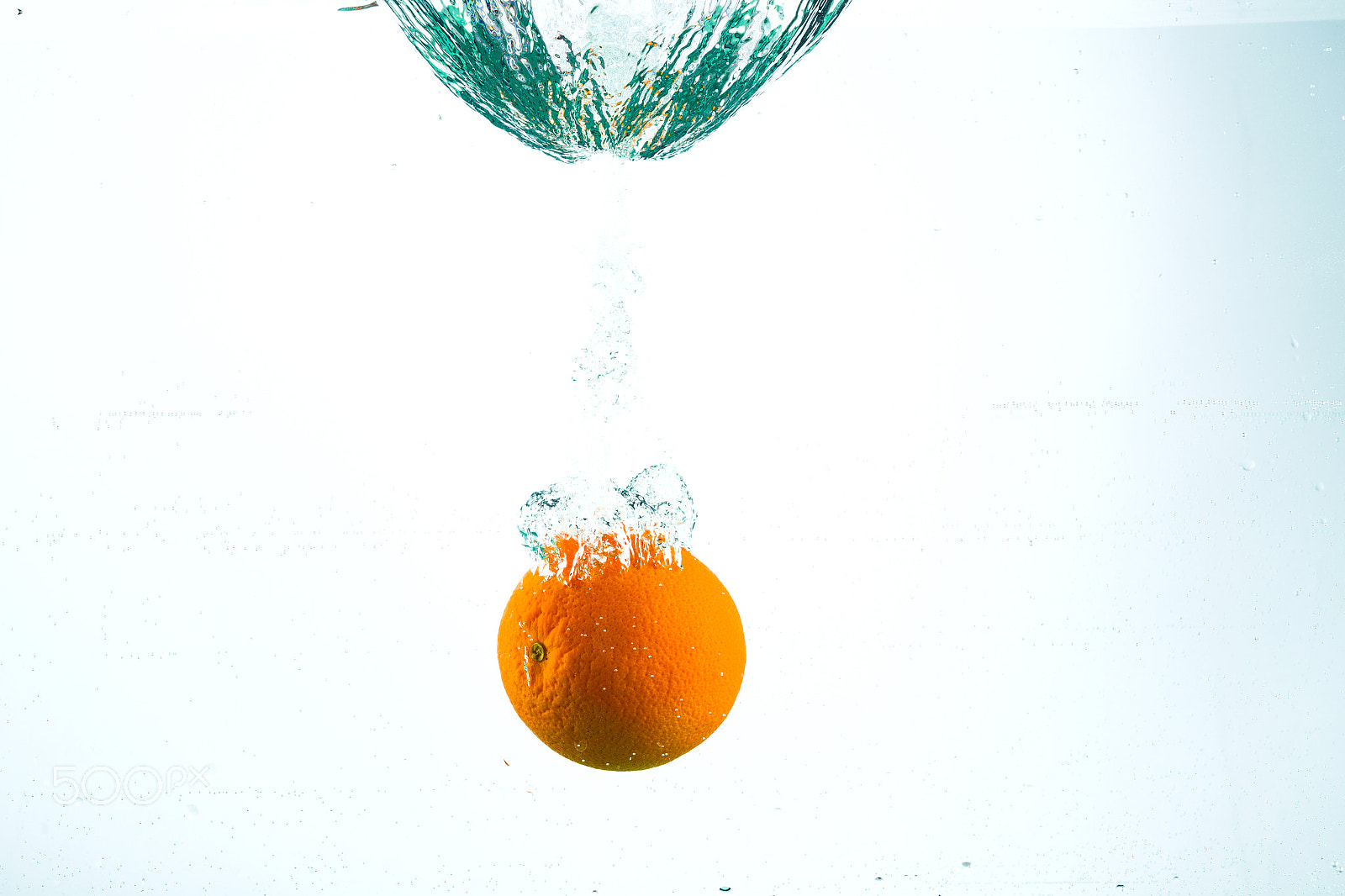 Canon EOS-1D Mark IV sample photo. Orange in streams of water on a white background photography