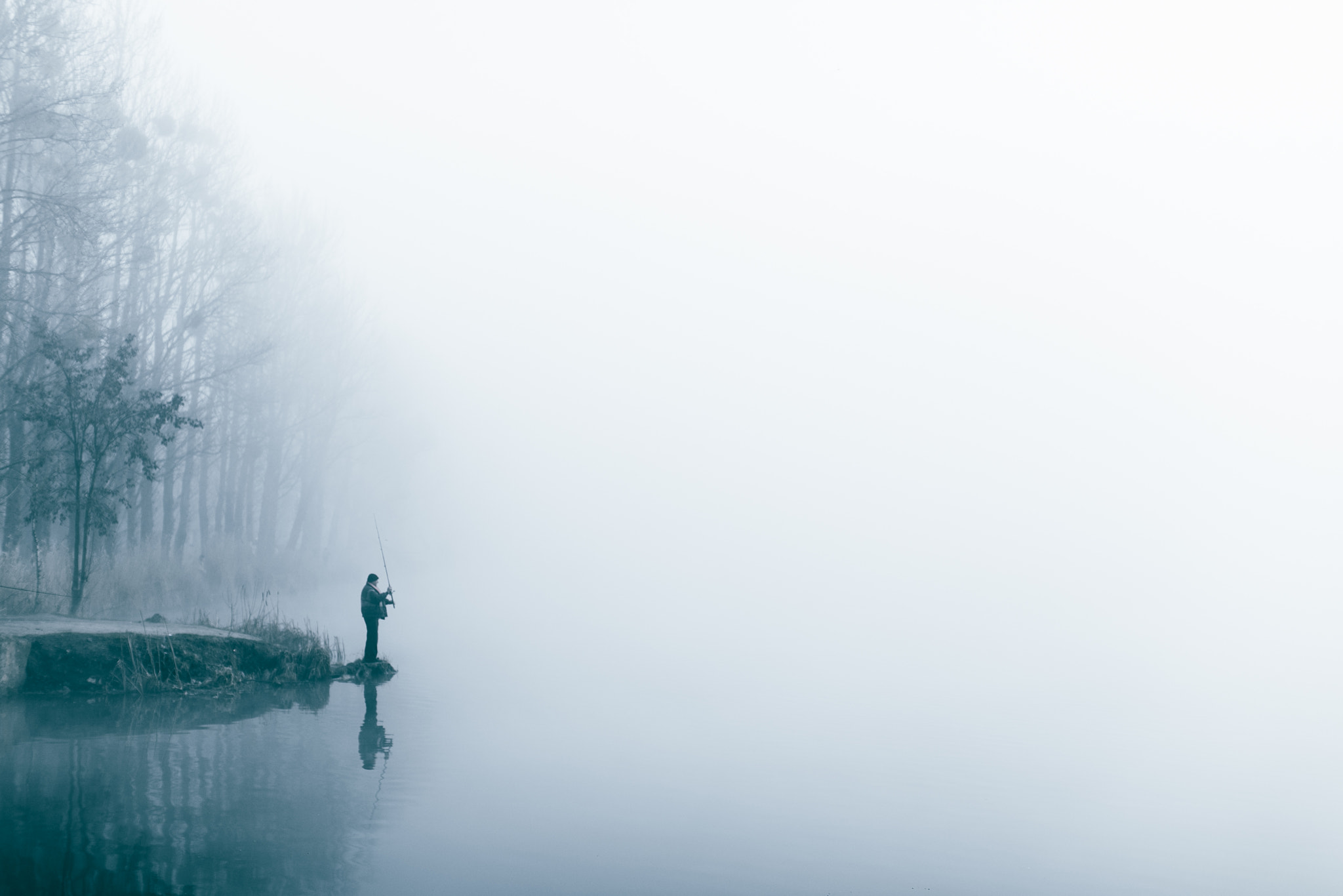Canon EF 50mm F1.2L USM sample photo. Fishing on the lake. fog. minimalism photography
