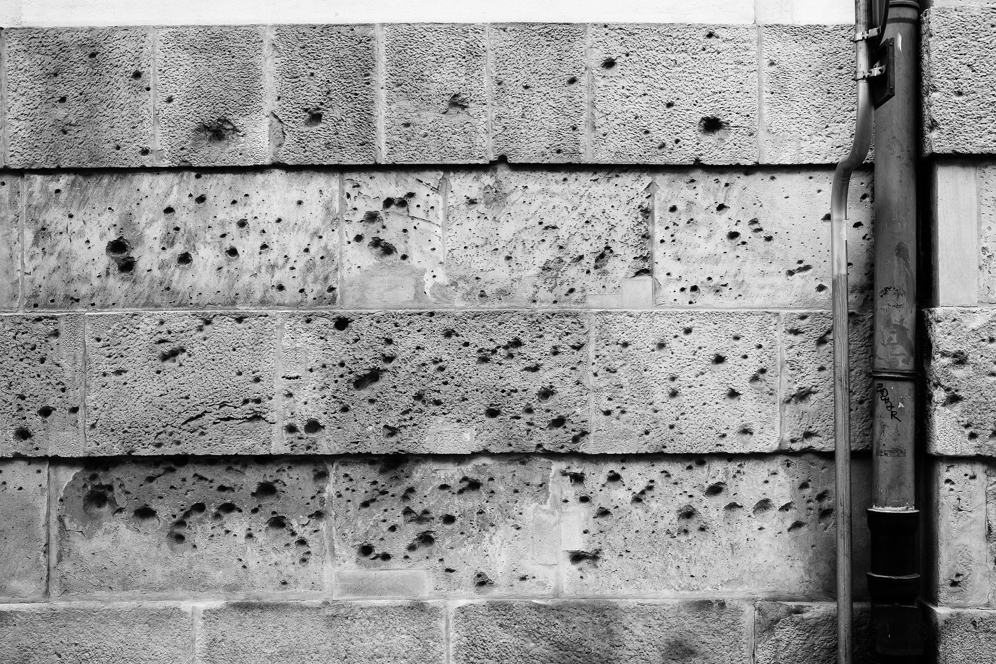 Fujifilm X-Pro1 sample photo. Wall with bullet holes photography