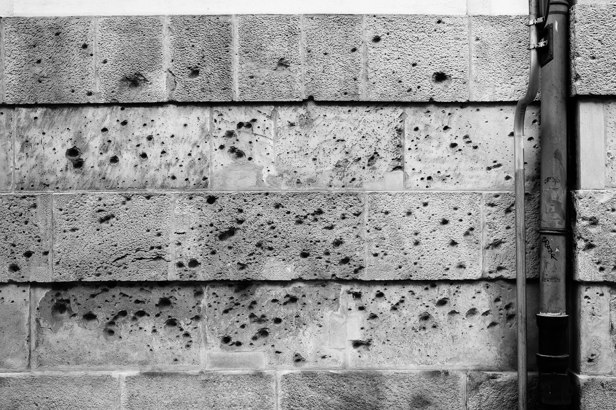 Fujifilm XF 18-55mm F2.8-4 R LM OIS sample photo. Wall with bullet holes photography