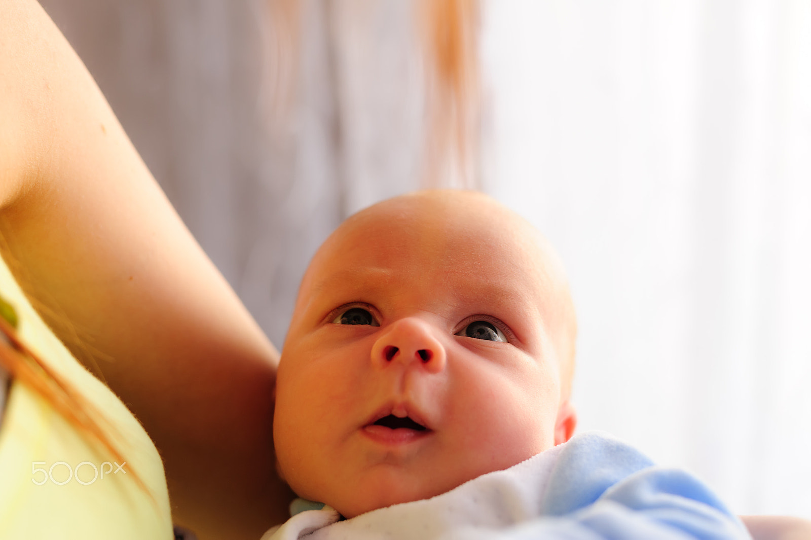 Nikon D700 sample photo. Cute baby girl makes a funny upset face on mothers hand photography