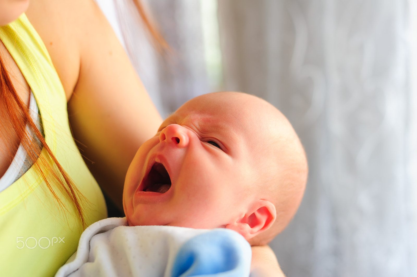 Nikon D700 sample photo. One month old baby yawning while holding her mothers hand photography