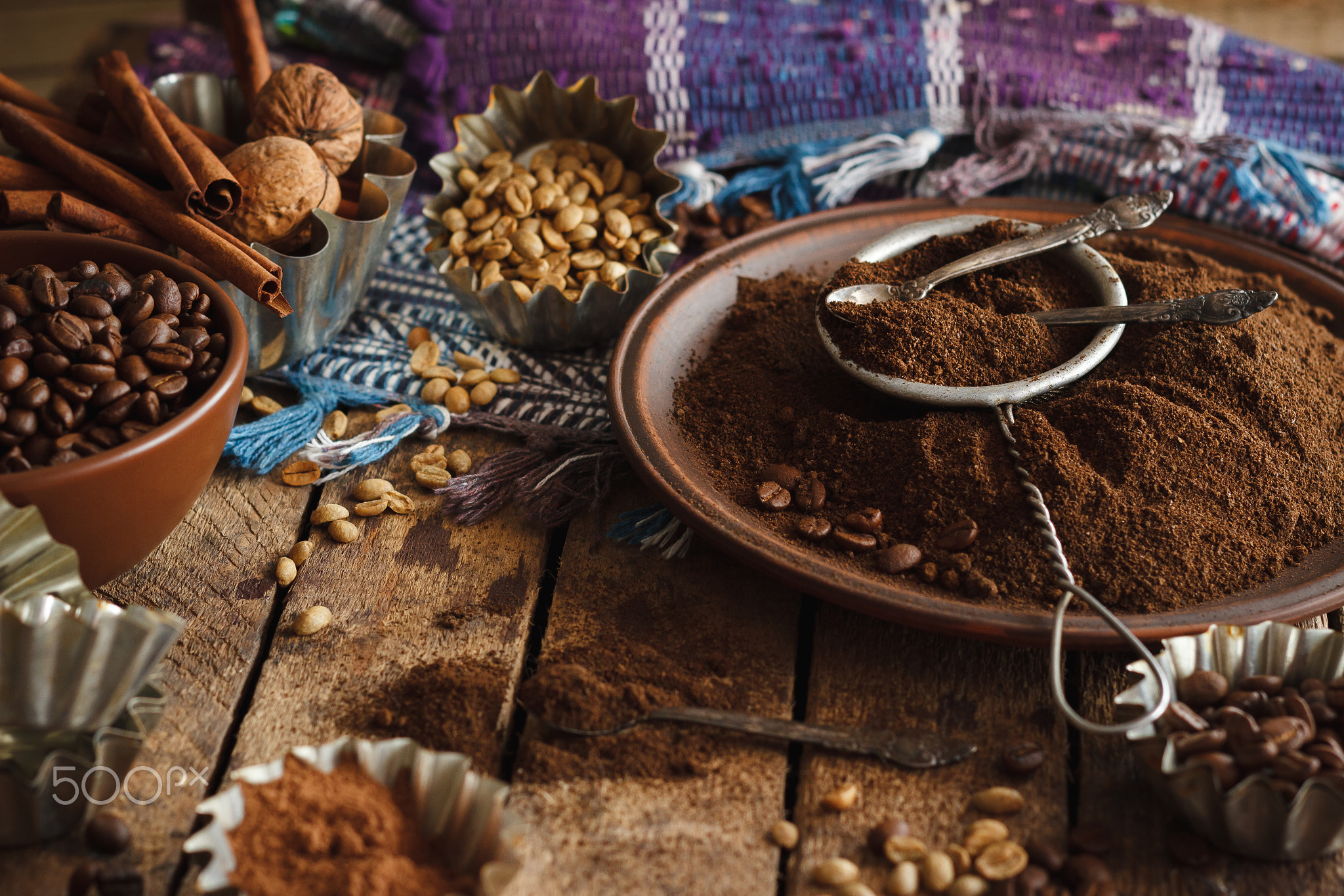 Roasted black and green coffee beans and ground coffee in the plate