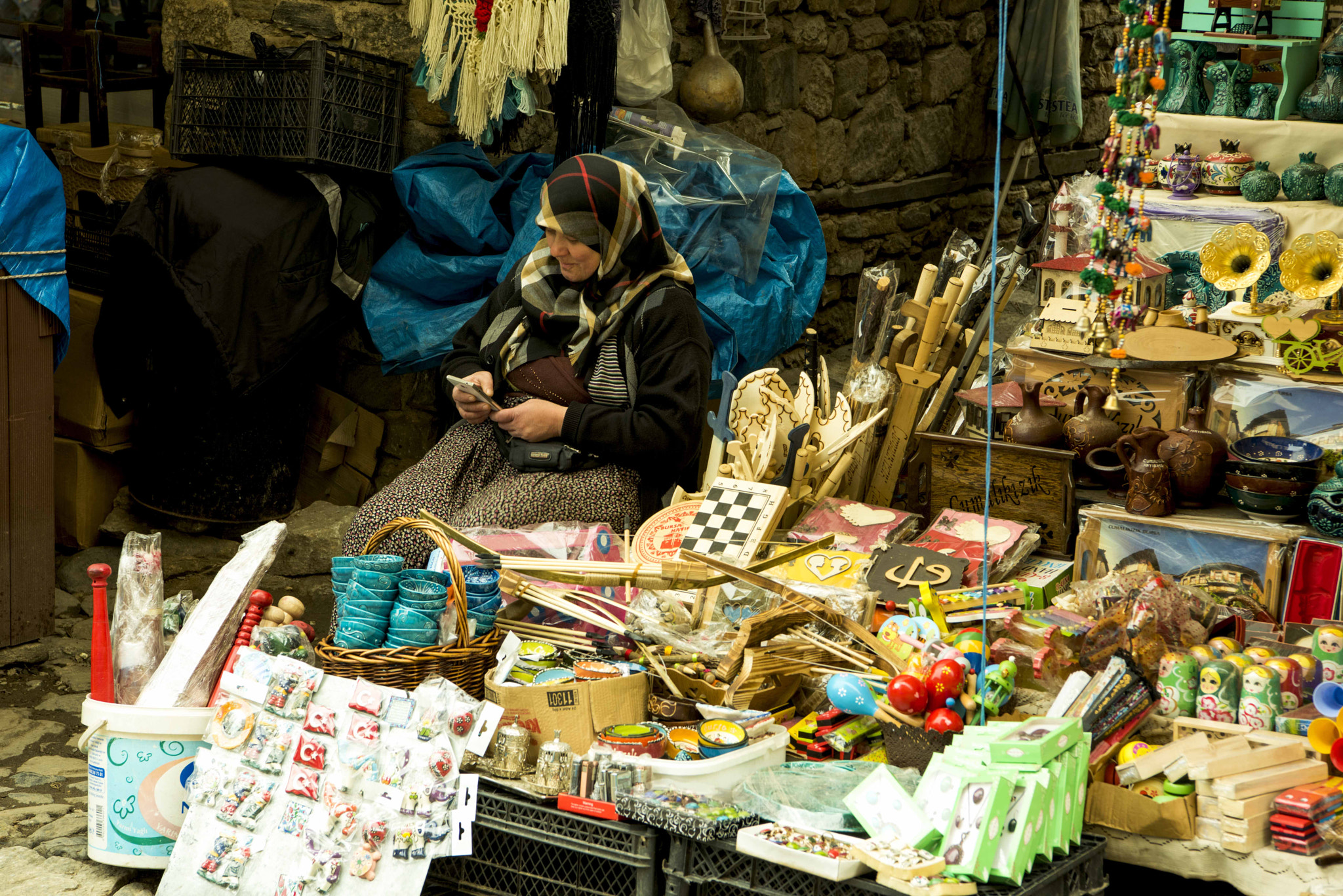 Nikon D810 sample photo. A steert vendor woman taking a look on her mobile photography