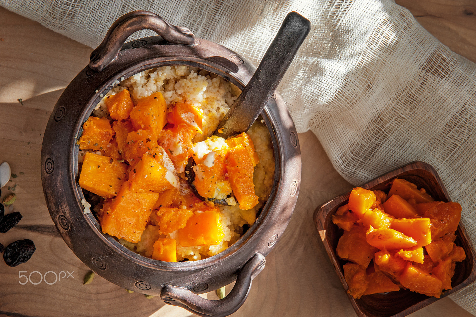 Nikon D700 sample photo. Vegetarian wheat porridge with large chunks of roasted pumpkin in a clay pot in a rustic style... photography