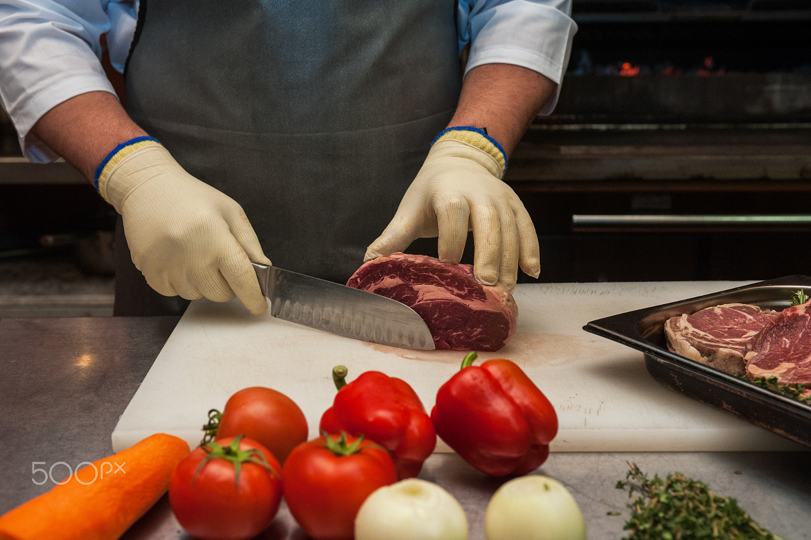 Nikon D700 sample photo. Chef cutting meat photography