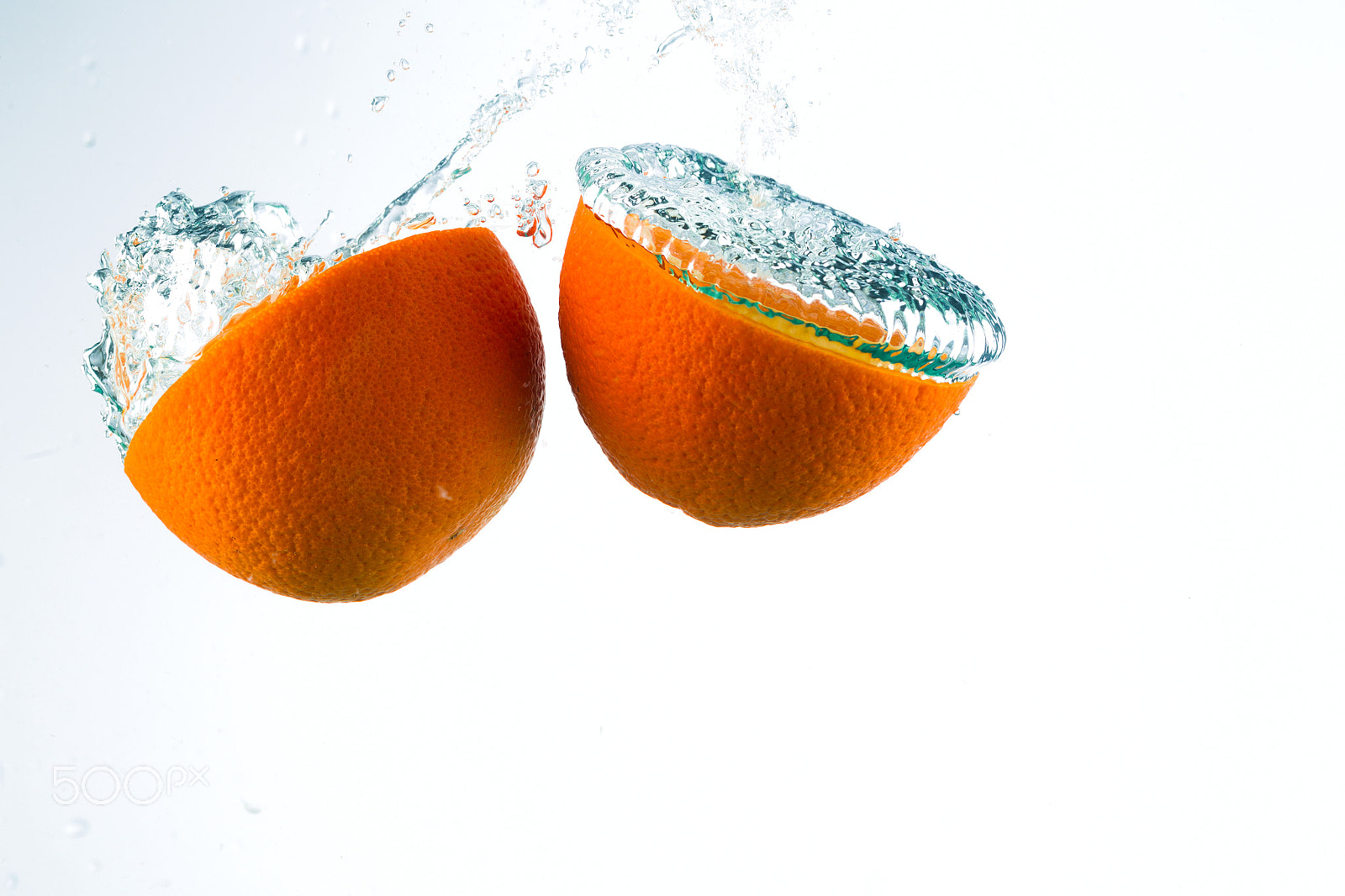 Canon EF 100mm F2.8L Macro IS USM sample photo. Orange in streams of water on a white background photography