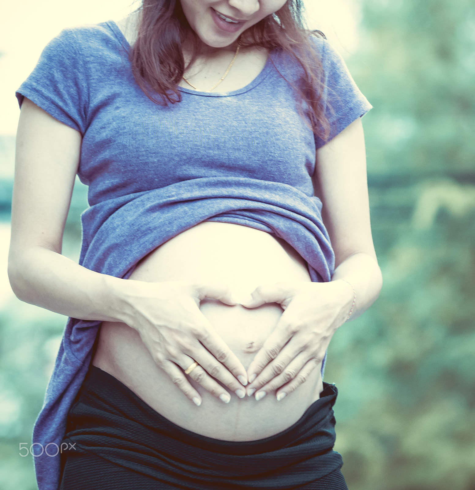 Canon EOS 7D + Canon EF 70-200mm F4L USM sample photo. Pregnant woman touching her belly with hands shaped heart photography