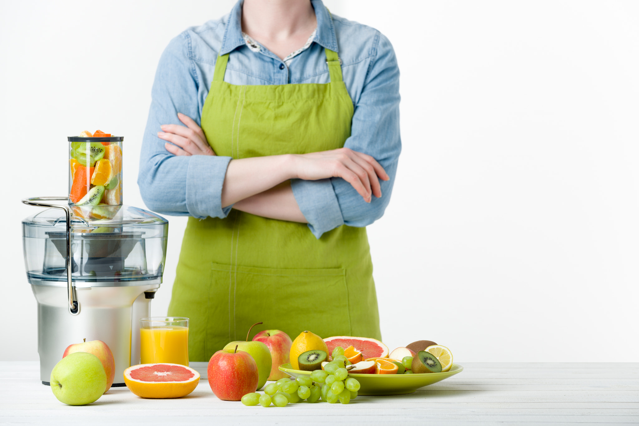 Nikon D810 sample photo. Anonymous woman wearing an apron, preparing fresh fruit juice using modern electric juicer,... photography