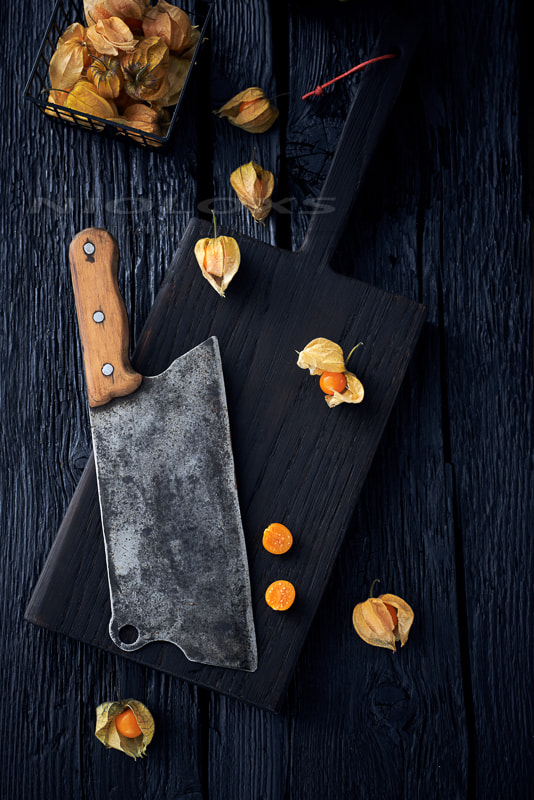 Nikon D610 sample photo. Golden berries or physalis fruit and chopper on a dark cutting b photography