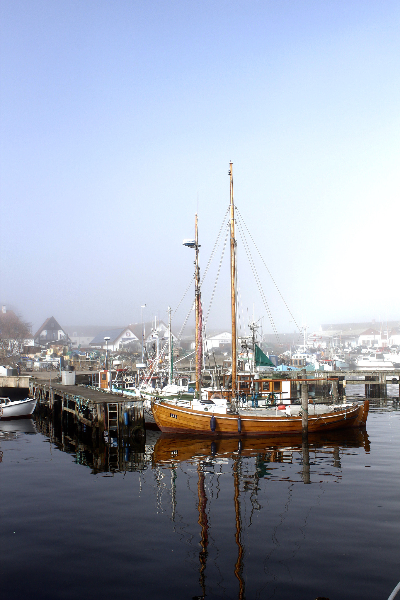 Canon EOS 600D (Rebel EOS T3i / EOS Kiss X5) + Canon EF-S 18-55mm F3.5-5.6 IS II sample photo. Sea fog wondering if to swallow the harbour photography