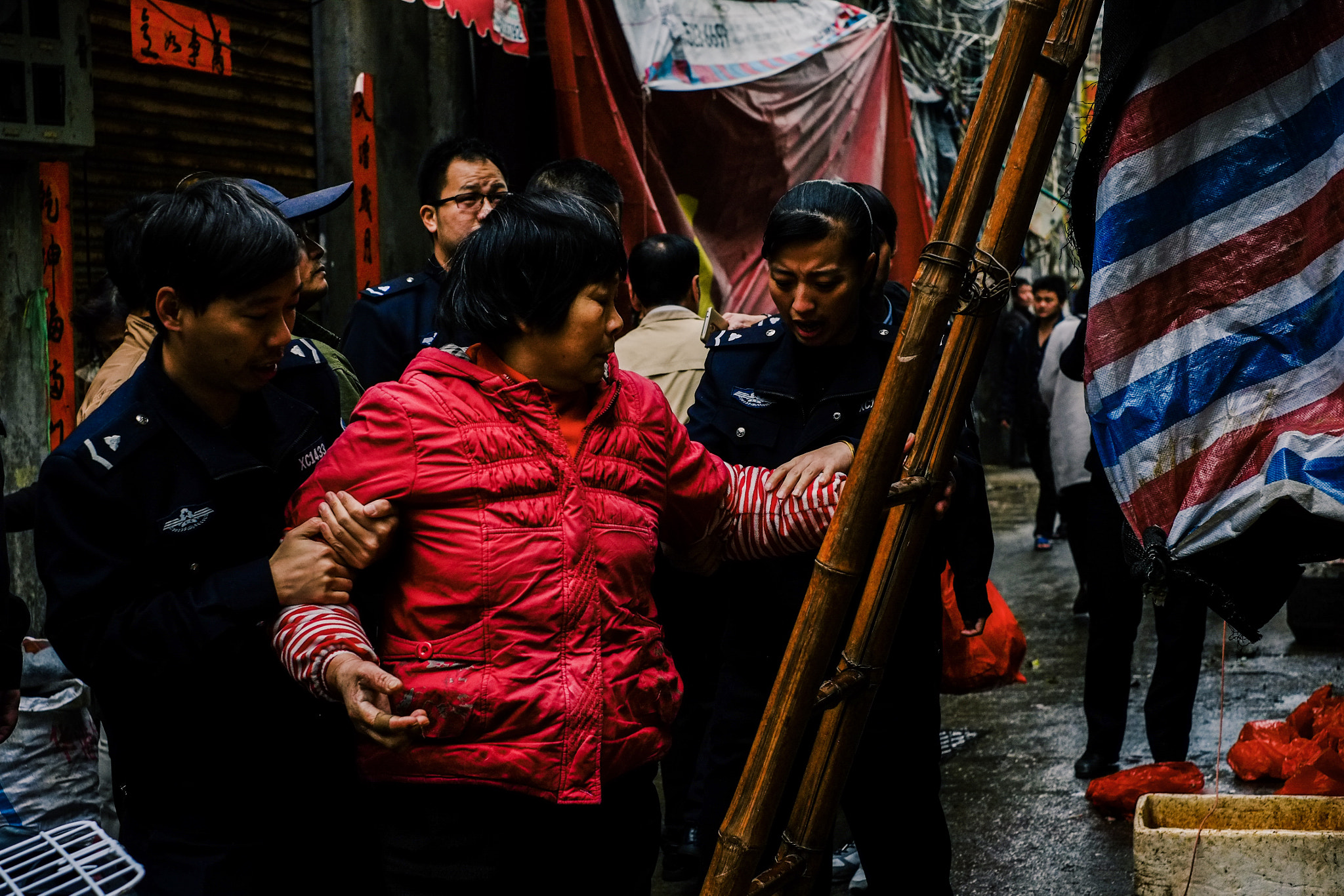Fujifilm X-Pro1 + Fujifilm XF 35mm F1.4 R sample photo. A woman & city policemen photography