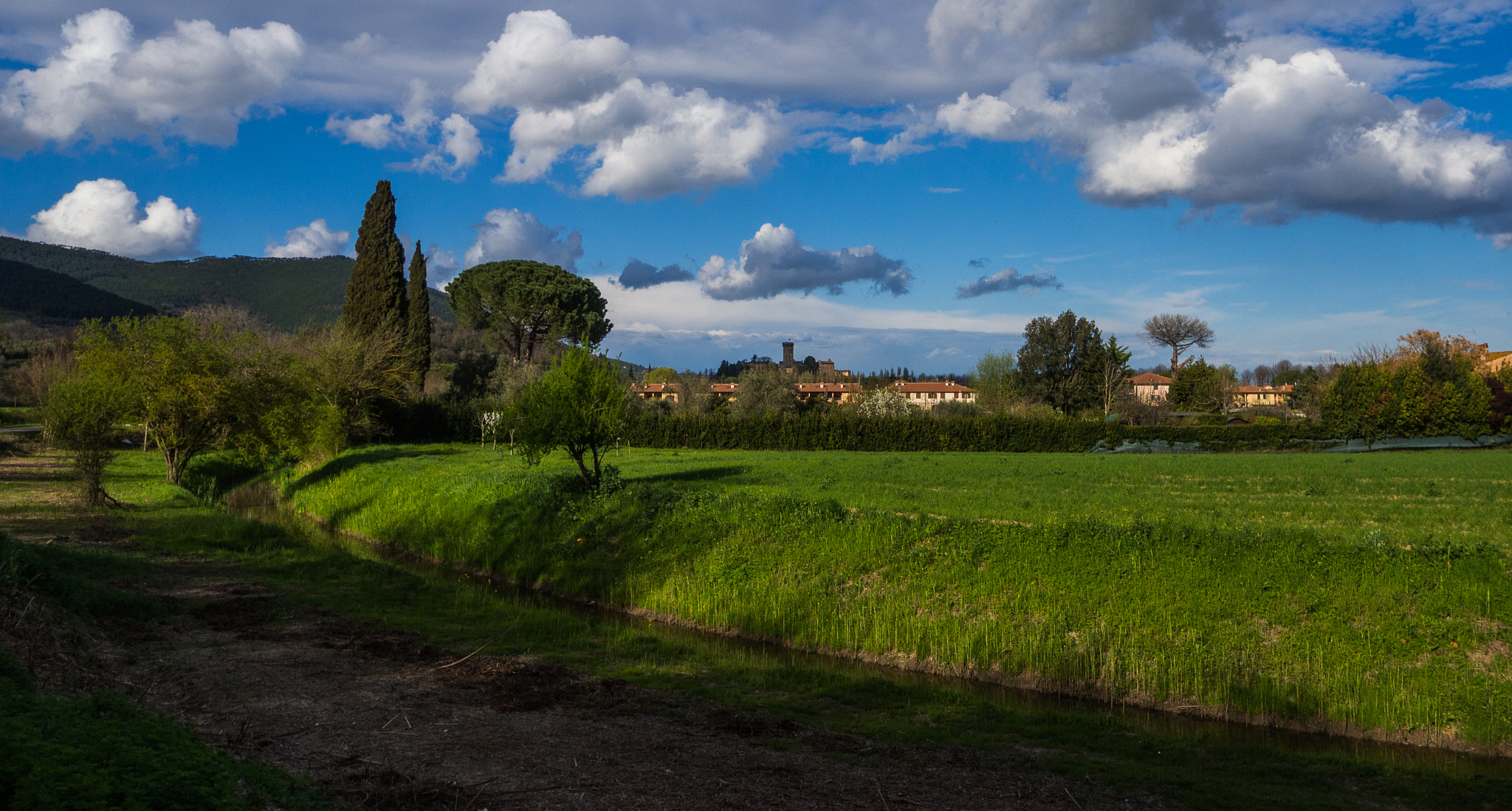 Olympus OM-D E-M10 + OLYMPUS M.12mm F2.0 sample photo. Clouds over the village photography