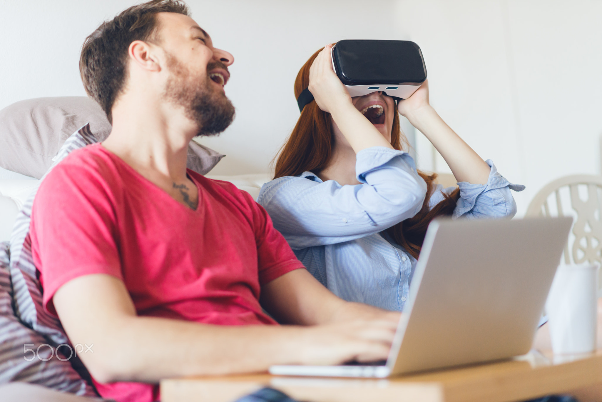 Young couple using VR headsets