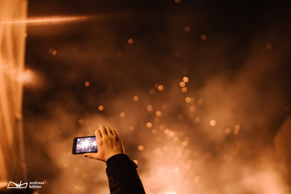 Hand holding smartphone and capturing sparkles