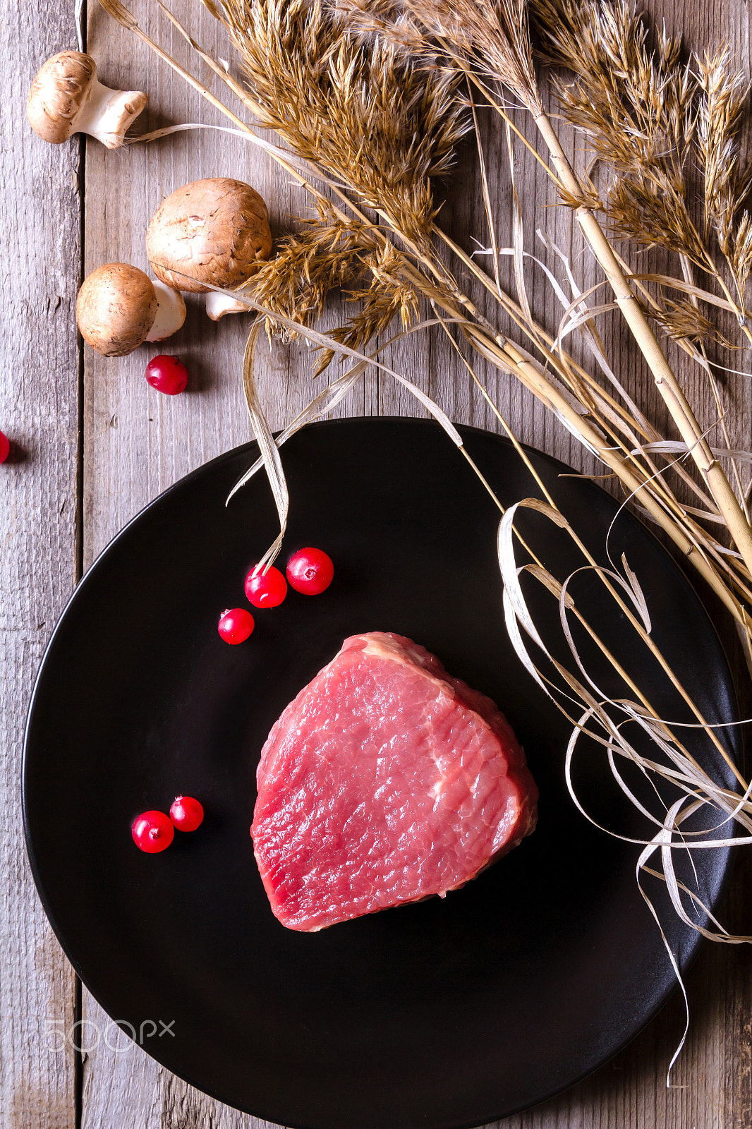 Canon EOS 60D sample photo. Fresh game meat on black plate and wooden table photography