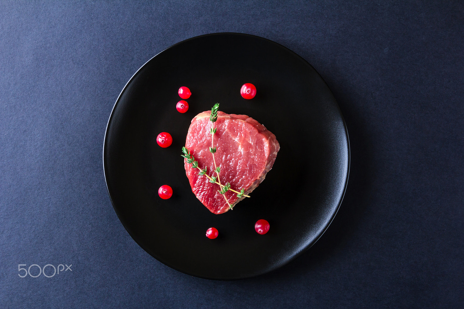 Canon EOS 60D sample photo. Raw meat on black plate and dark background photography