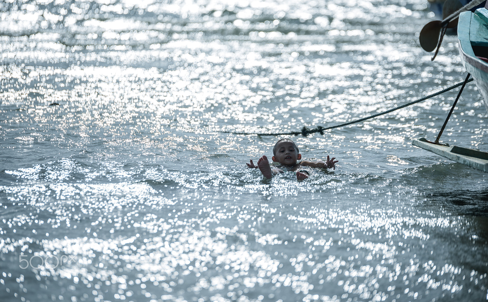 Nikon D750 + Tamron SP 70-200mm F2.8 Di VC USD sample photo. Unidentified child play  floating in the sea. photography
