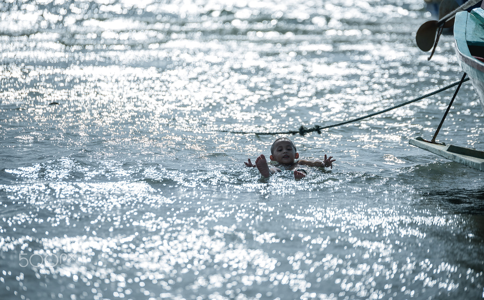 Tamron SP 70-200mm F2.8 Di VC USD sample photo. Unidentified child play  floating in the sea. photography