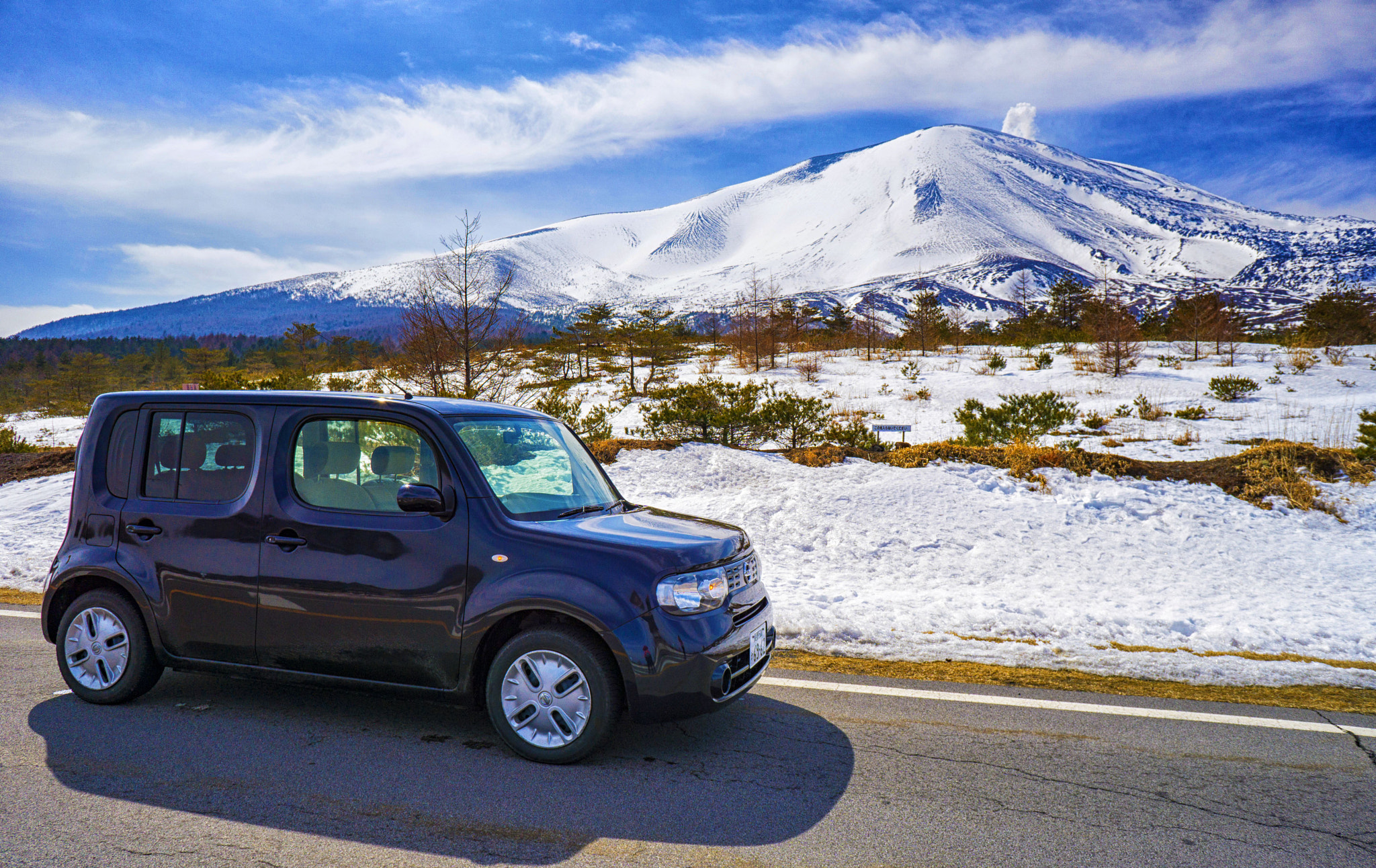 Sony a6000 sample photo. My car and the shield volcano : smoke emitted from the volcano photography