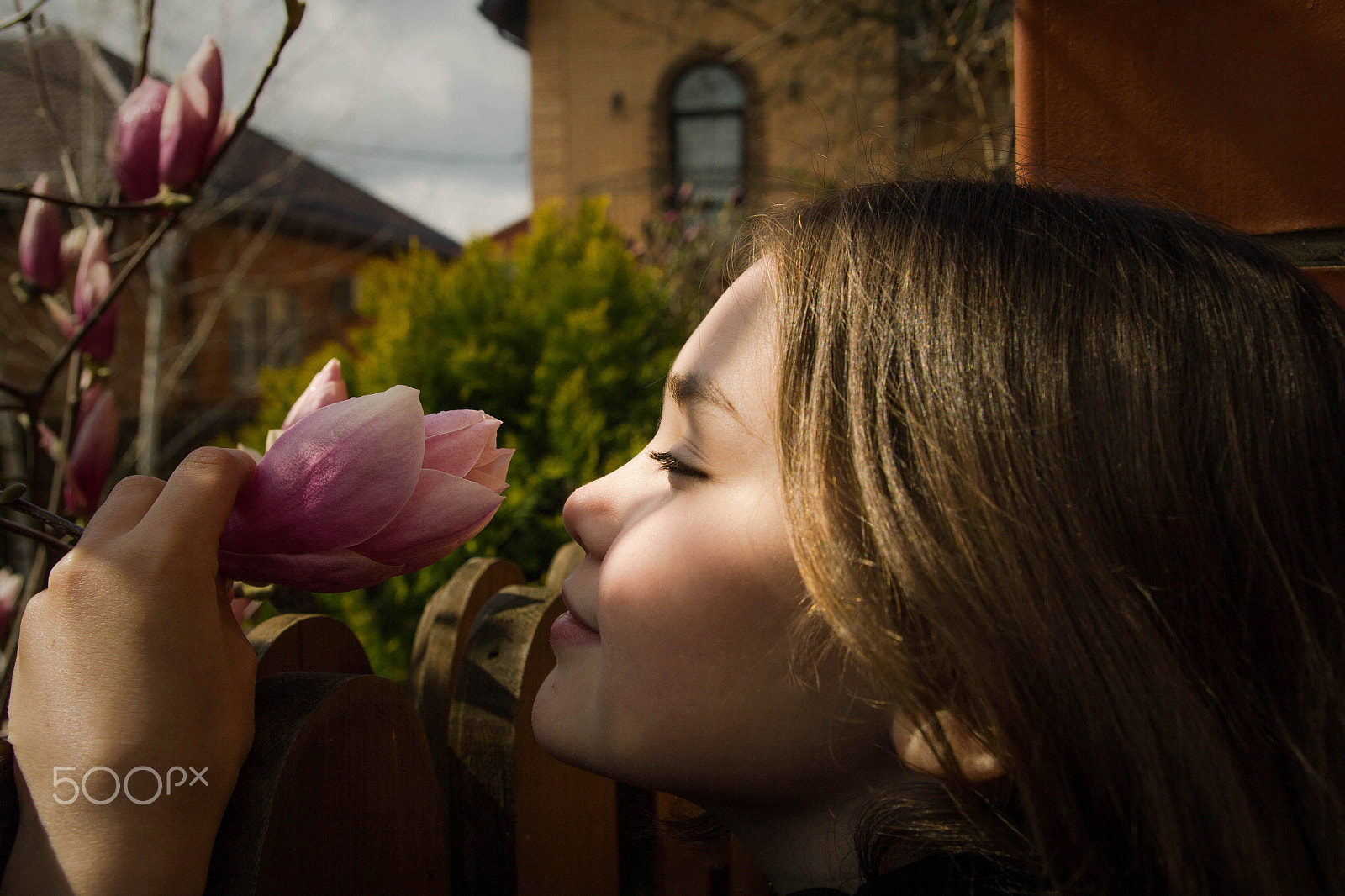 Canon EOS 60D sample photo. A girl sniffing a magnolia flower. spring.... photography