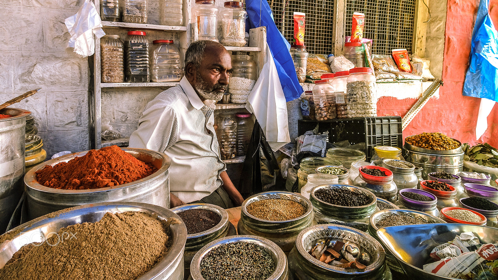 Sony Cyber-shot DSC-WX500 sample photo. A man selling spices in a market photography