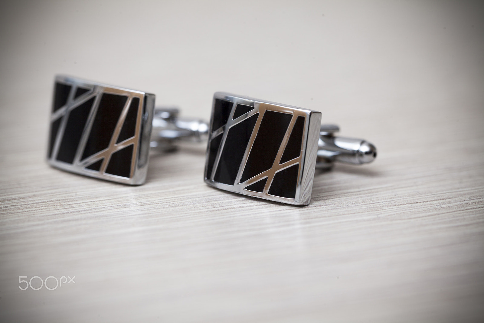 Canon EF 100mm F2.8L Macro IS USM sample photo. Cufflinks on white background photography