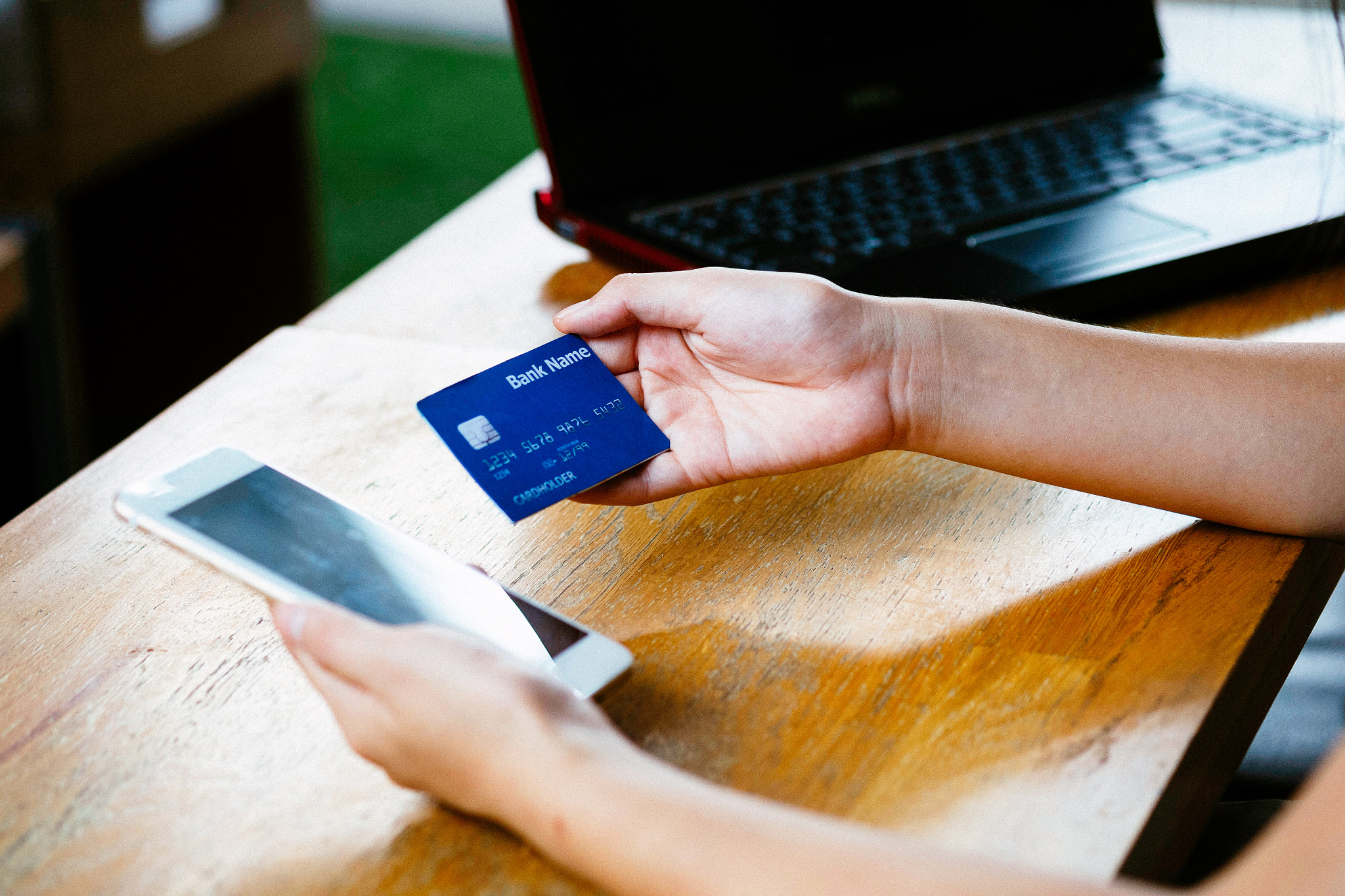 Fujifilm X-A2 + Fujifilm XF 60mm F2.4 R Macro sample photo. Woman hands holding credit card and using smart phone, online sh photography