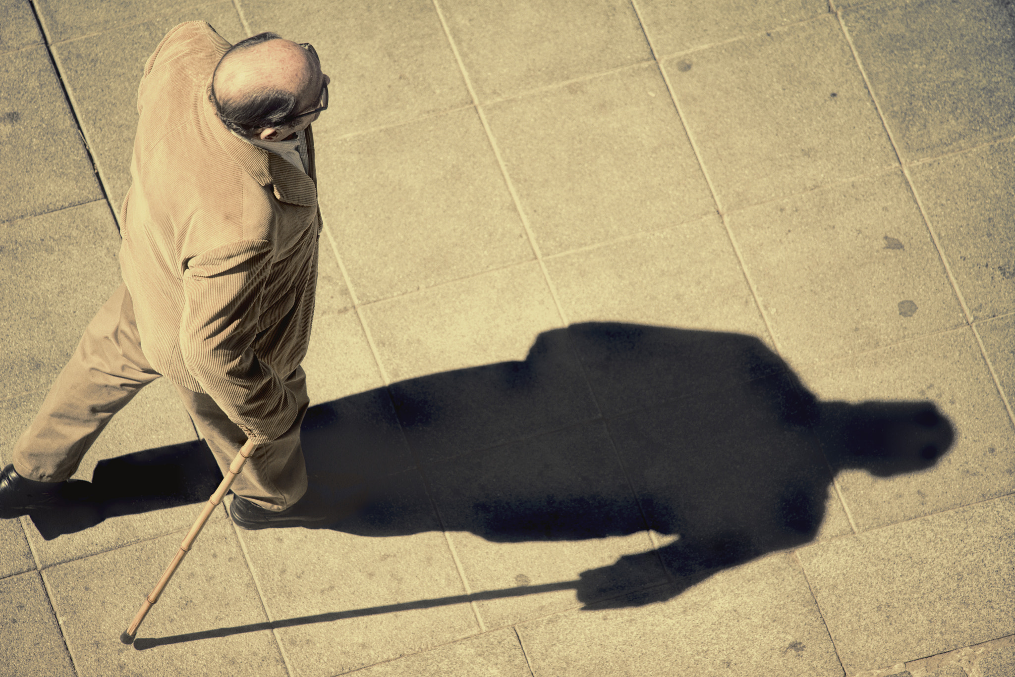 Nikon D810 sample photo. Old man walking down the street with a walking stick photography