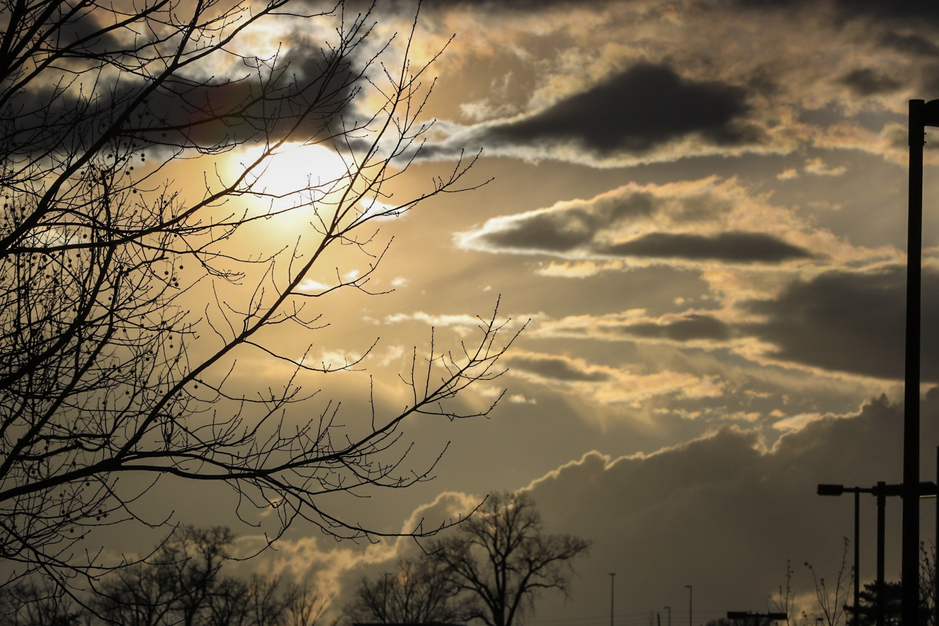 Canon EOS 750D (EOS Rebel T6i / EOS Kiss X8i) + Canon EF 70-200mm F4L USM sample photo. Sun captured behind storm clouds as sunset meets thunderstorm. photography