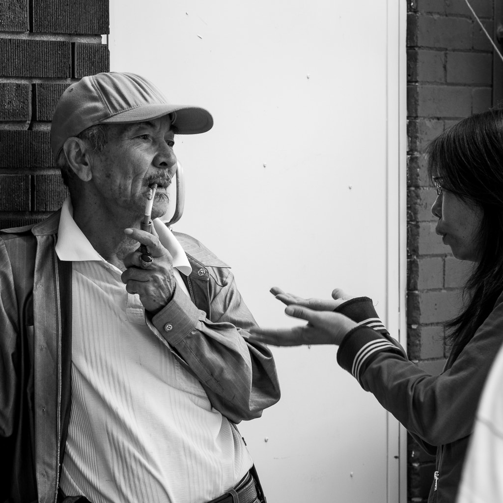 Pentax smc DA 70mm F2.4 AL Limited sample photo. A couple of people chatting in toronto's chinatown. photography