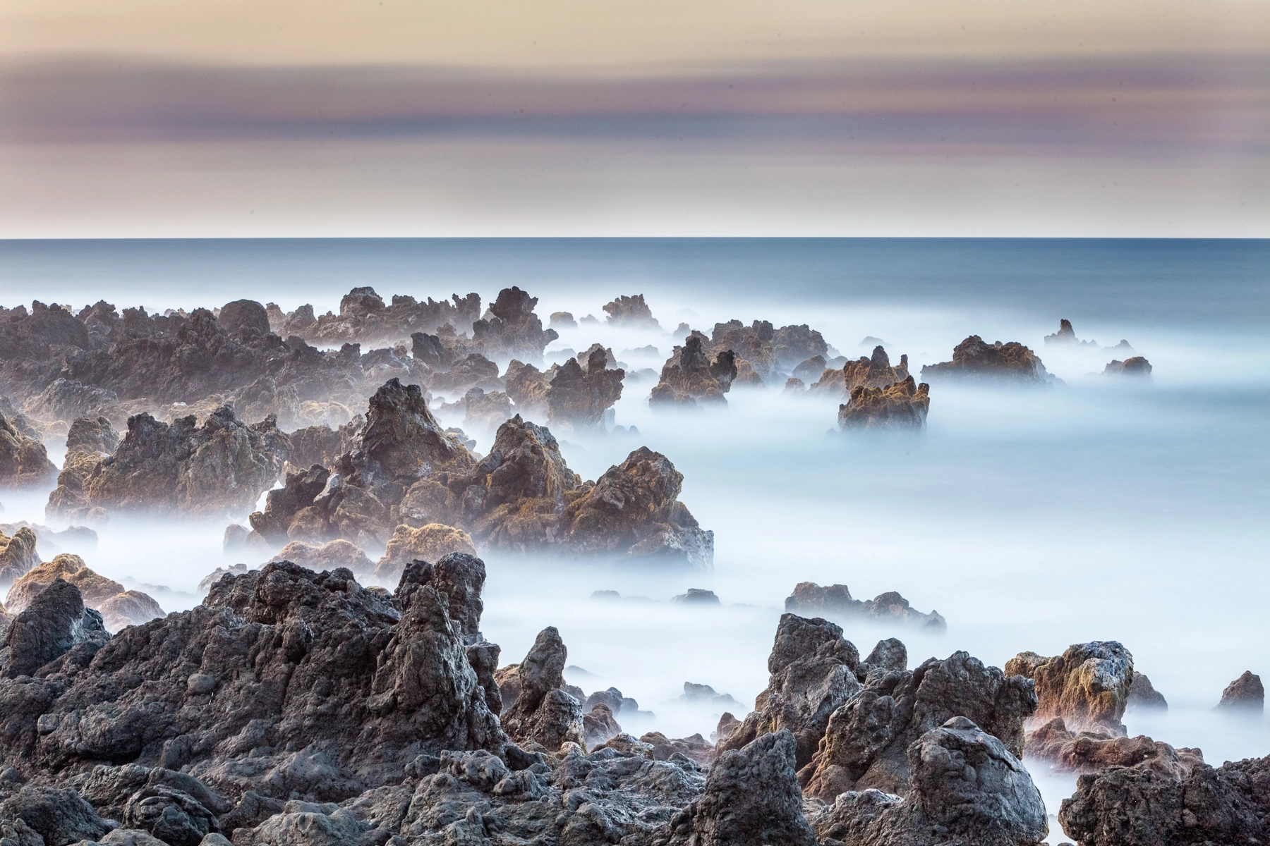 Canon EOS 5D Mark II + Canon EF 70-200mm F2.8L IS USM sample photo. Long exposure of waves vs lava rocks photography