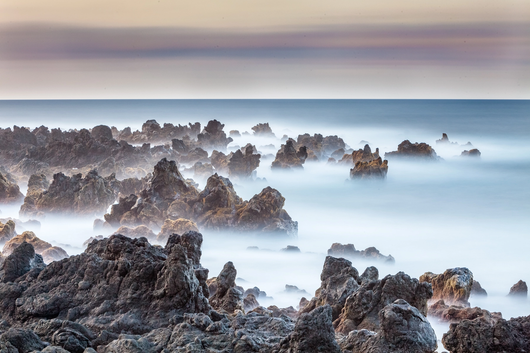 Canon EOS 5D Mark II sample photo. Long exposure of waves vs lava rocks photography