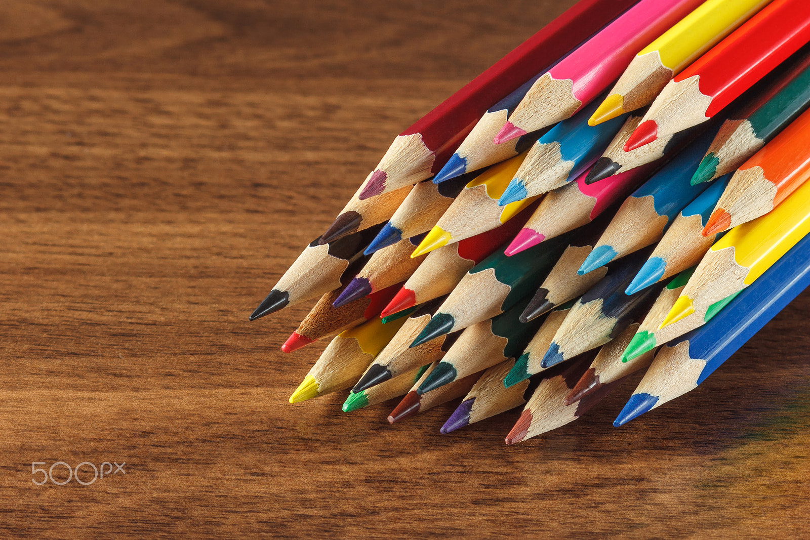 Canon EOS 600D (Rebel EOS T3i / EOS Kiss X5) + Canon EF 85mm F1.8 USM sample photo. Heap of colored pencils, wooden background photography