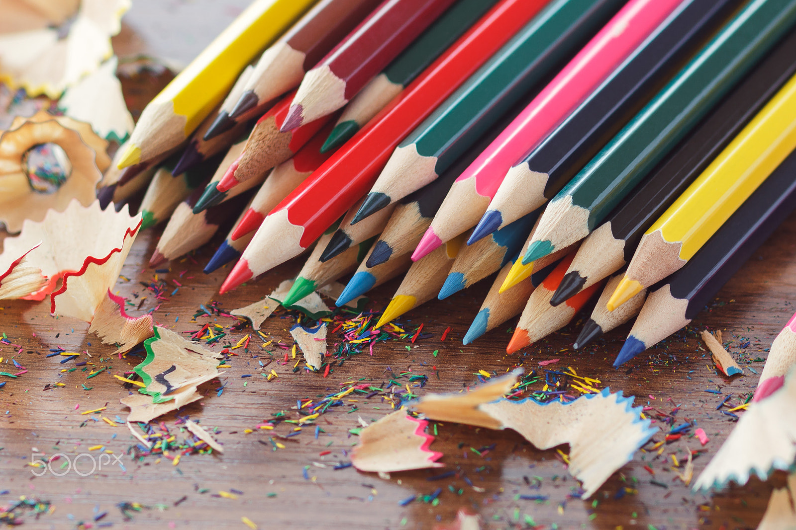 Canon EOS 600D (Rebel EOS T3i / EOS Kiss X5) + Canon EF 85mm F1.8 USM sample photo. Heap of colored pencils, wooden background photography
