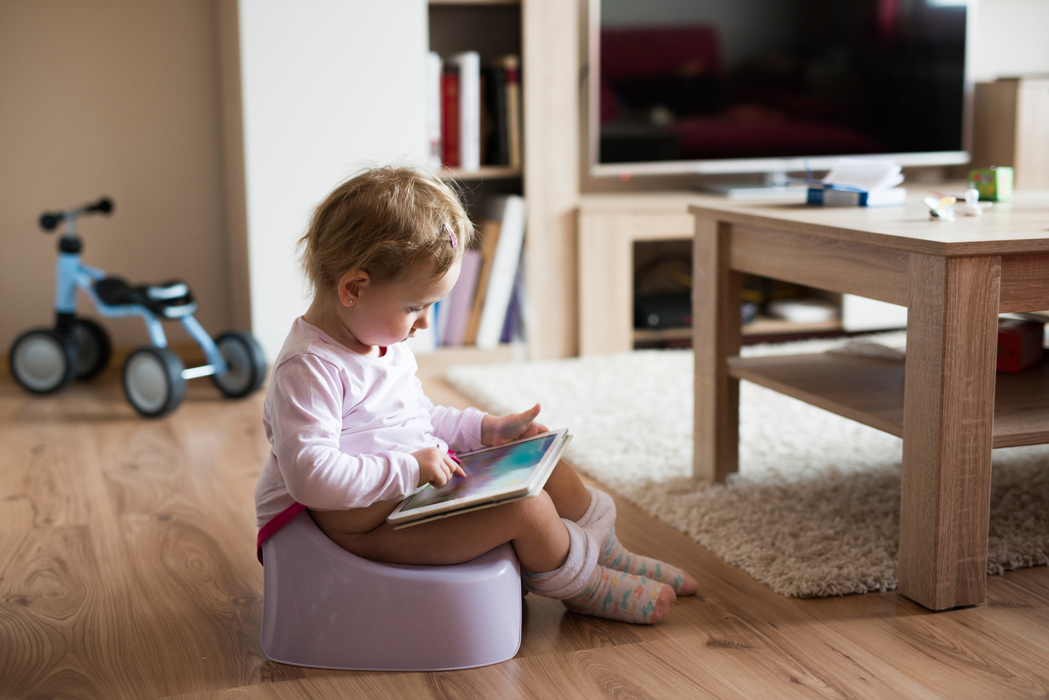 Nikon D800 + Sigma 50mm F1.4 DG HSM Art sample photo. Little girl at home sitting on potty playing with tablet photography