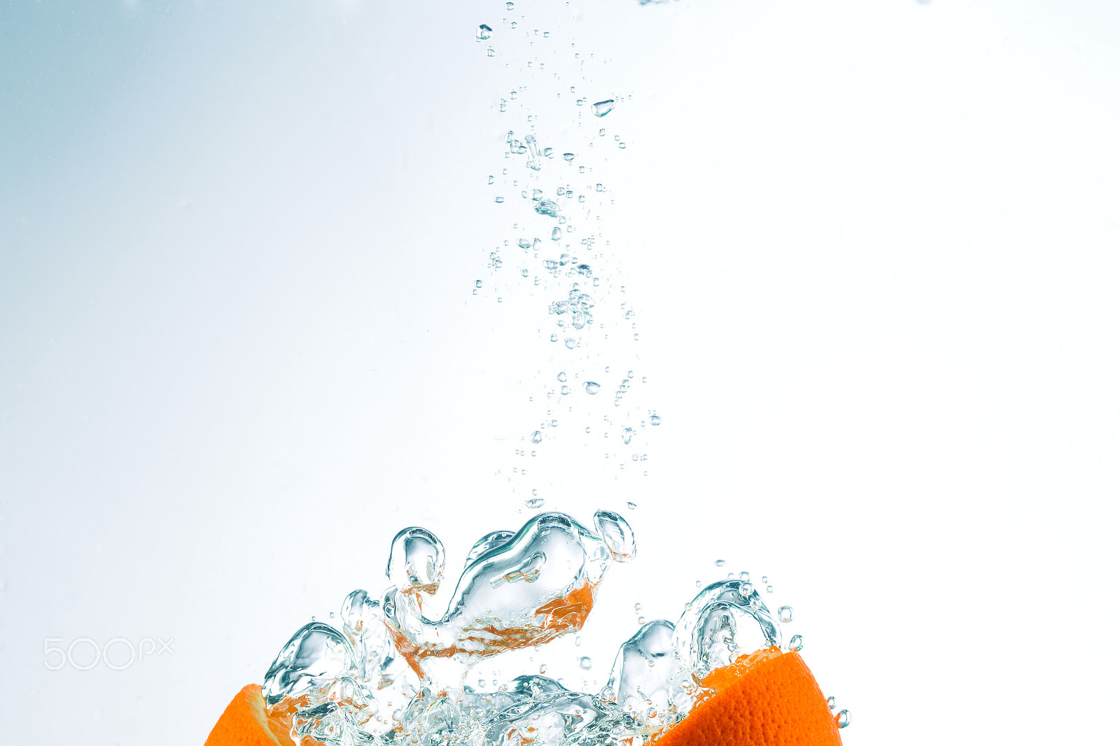 Canon EF 100mm F2.8L Macro IS USM sample photo. Orange in streams of water on a white background photography