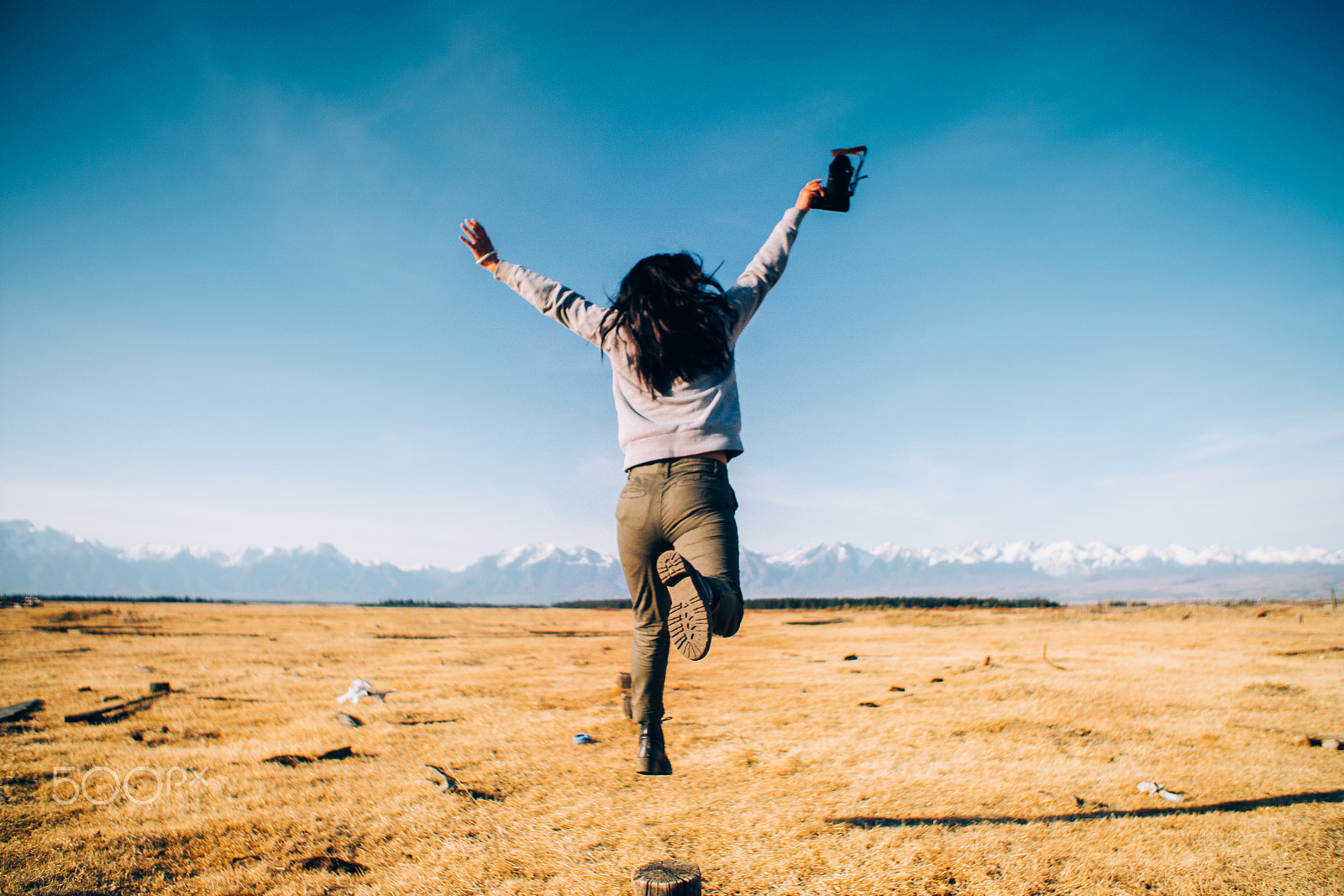 Sony a6300 + Canon EF 24-70mm F2.8L USM sample photo. Girl with camera is jumping with background of fie photography