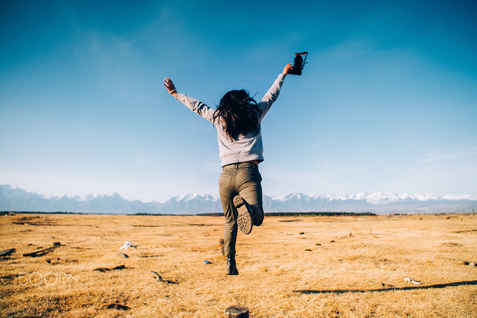 Sony a6300 + Canon EF 24-70mm F2.8L USM sample photo. Girl with camera is jumping with background of fie photography