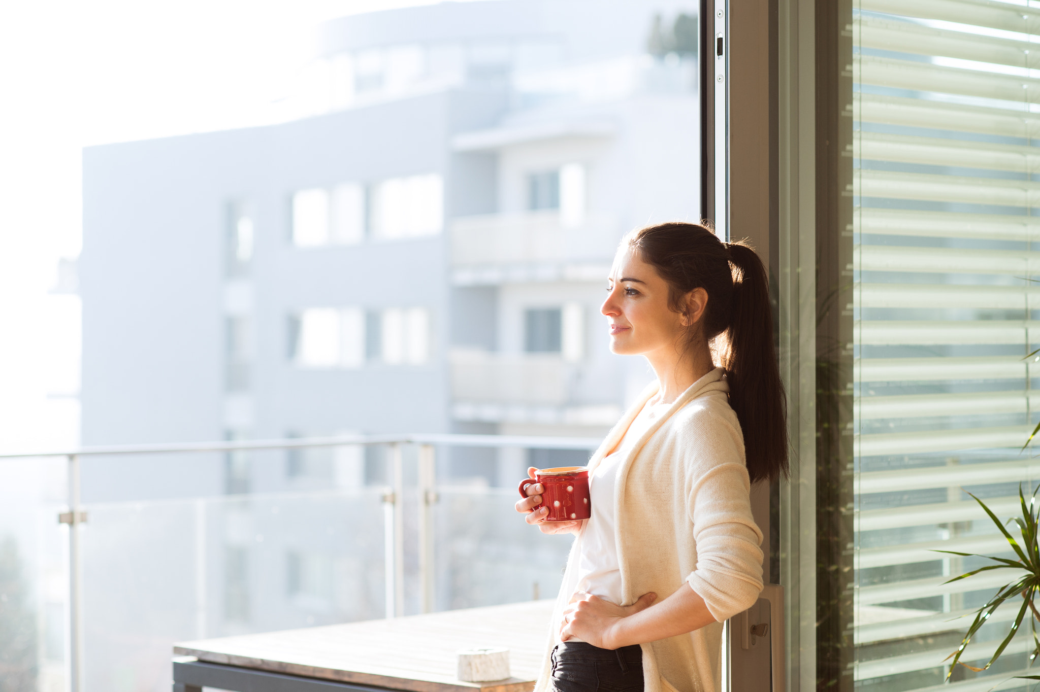 Nikon D4S sample photo. Woman relaxing on balcony holding cup of coffee or tea photography