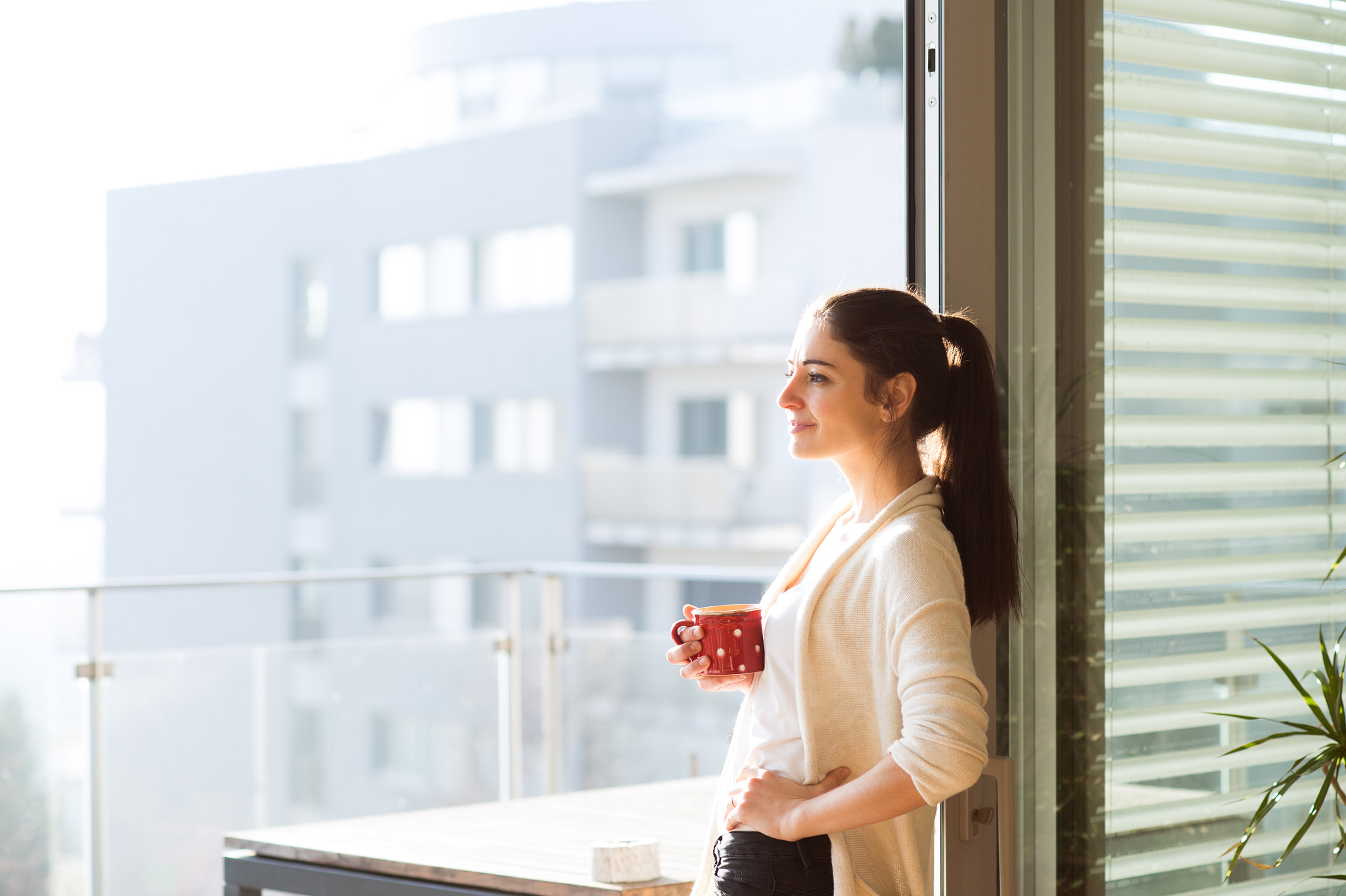 Nikon D4S + Nikon AF Nikkor 85mm F1.8D sample photo. Woman relaxing on balcony holding cup of coffee or tea photography