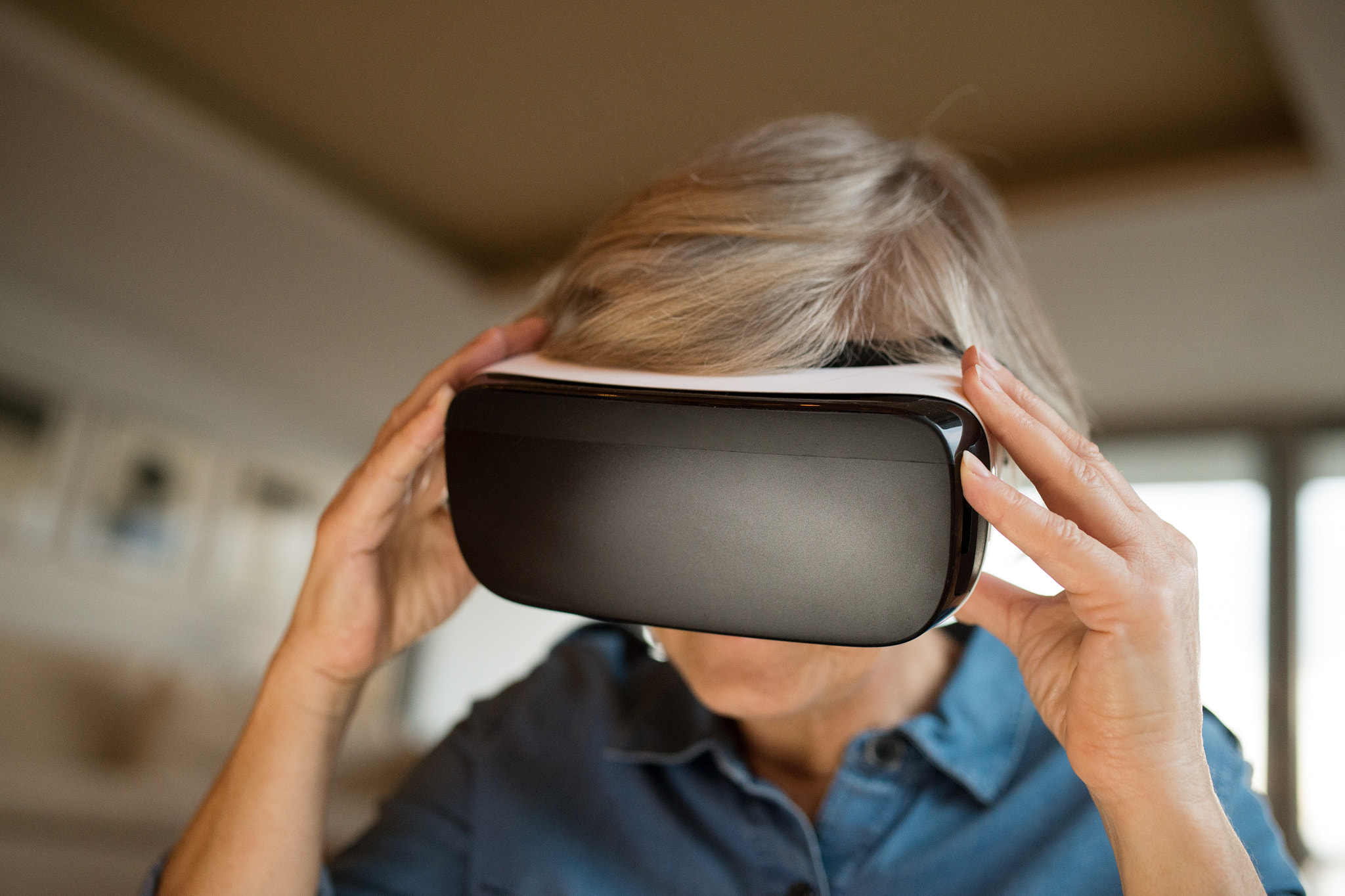 Nikon D4S sample photo. Senior woman wearing virtual reality goggles at home photography