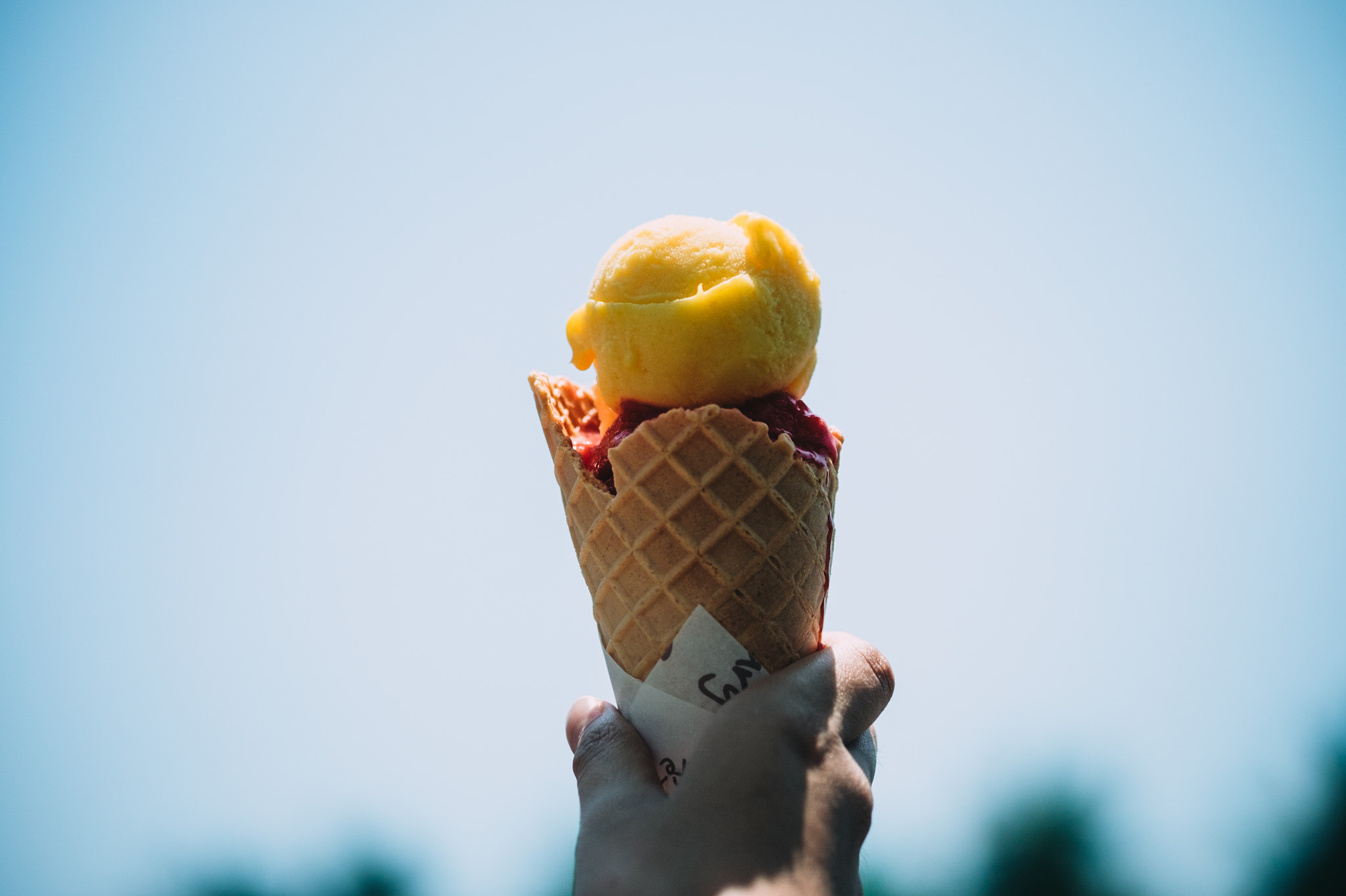 Fujifilm X-T10 + Fujifilm XF 60mm F2.4 R Macro sample photo. Gelato ice cream cone held up to the hot summer photography