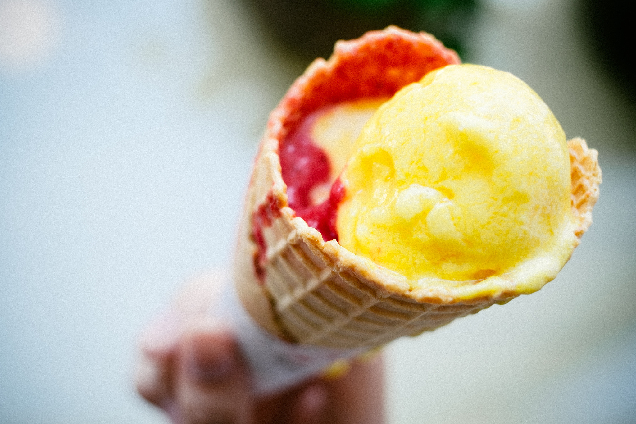 Fujifilm X-T10 + Fujifilm XF 60mm F2.4 R Macro sample photo. Gelato ice cream cone held up to the hot summer photography