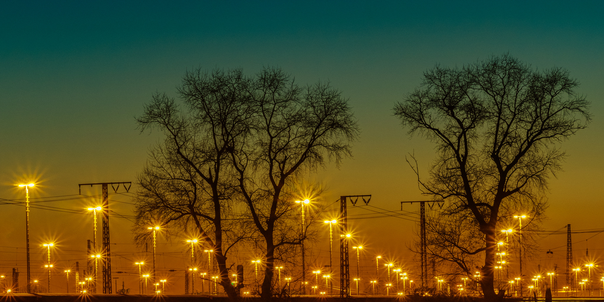 Olympus OM-D E-M1 + Panasonic Lumix G X Vario 35-100mm F2.8 OIS sample photo. The lights of the railway station. photography