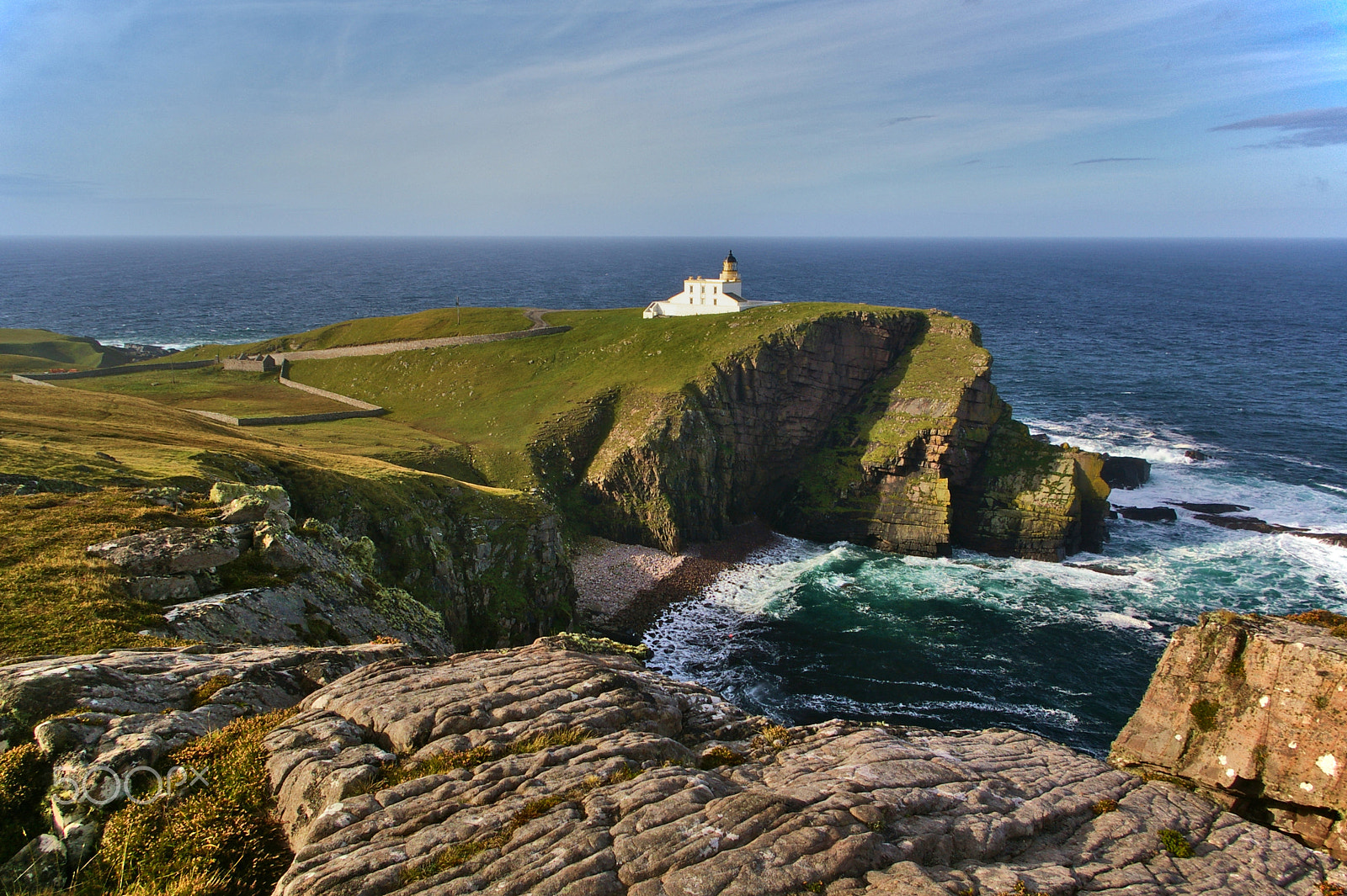 Pentax K100D sample photo. Lighthouse on a steep cliff above the sea photography