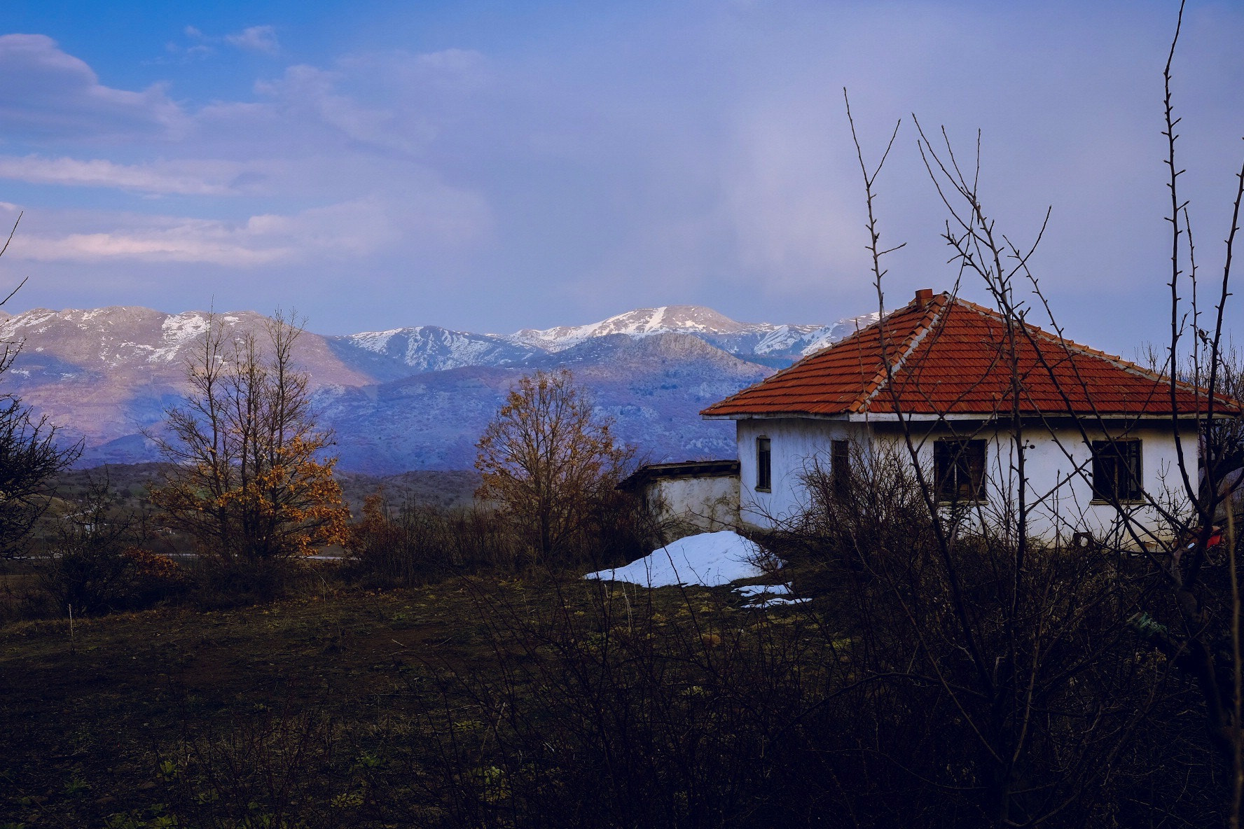 Fujifilm X-T1 sample photo. One hut watching the last moments of sun on the mountain tops across the valley. photography