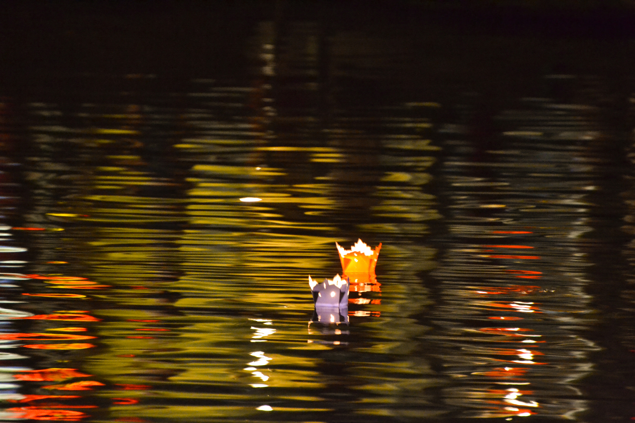 Nikon D3100 sample photo. Candles on paper boats floating on a river photography