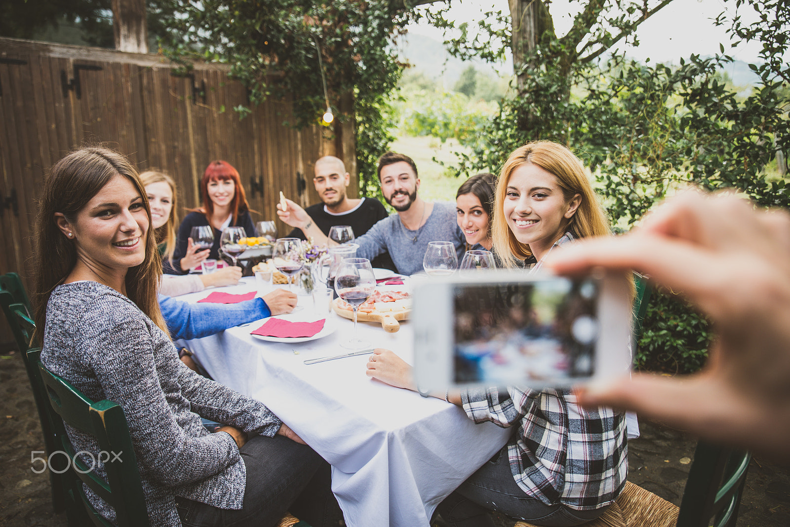 Nikon D610 sample photo. Friends having dinner in garden photography